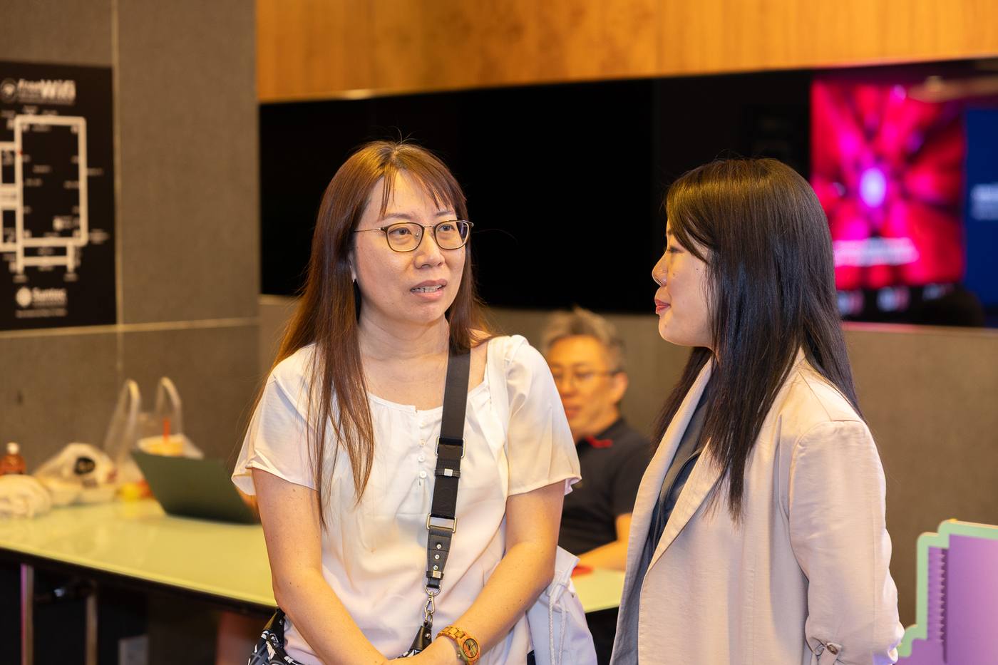 A Crestbrick associate listening closely to a client at an event