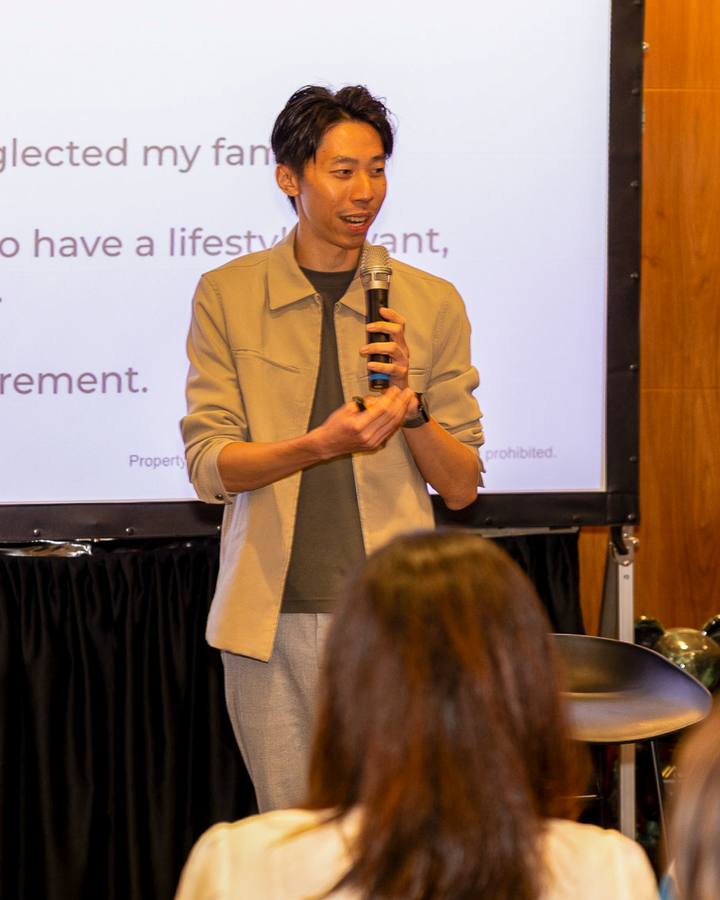 A Crestbrick realtor speaking to the room at a client event