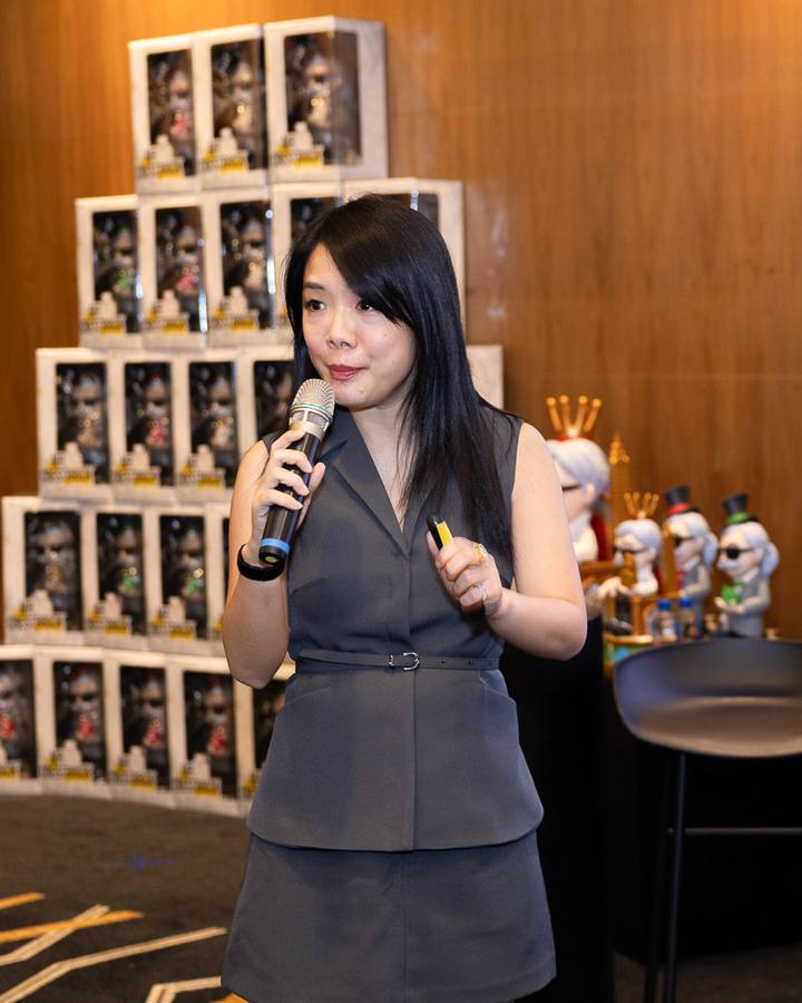 A Crestbrick realtor presenting with a microphone at a book launch event