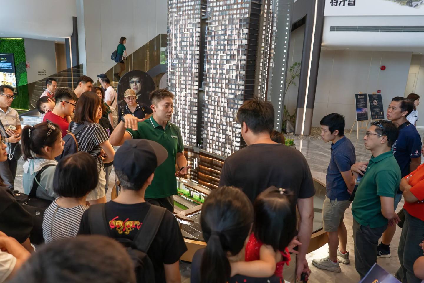 Clients studying a development&rsquo;s scale model at a Kuala Lumpur sales gallery