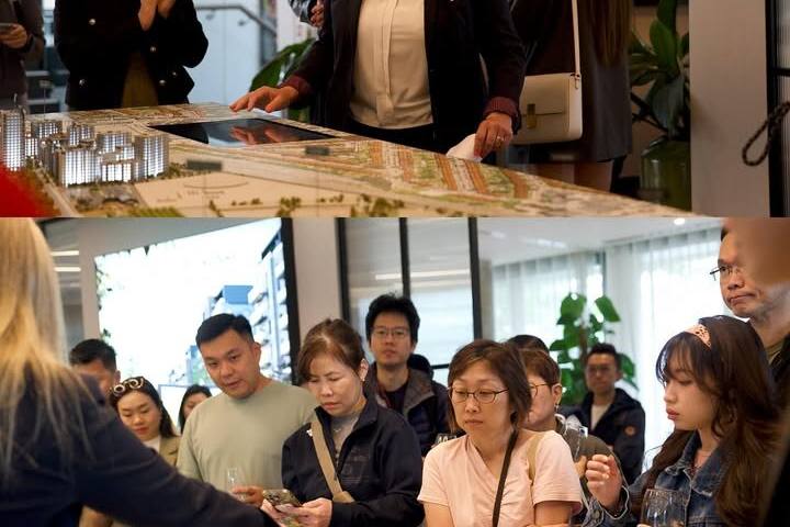 Clients studying a development’s scale model in a UK marketing suite